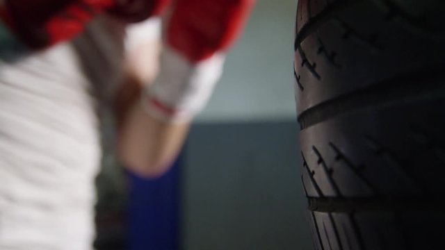 Boxer punching tire in slow motion