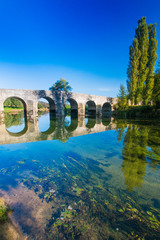 Fototapeta na wymiar Croatia, old stone bridge over the river Dobra and in Novigrad, Karlovac county 