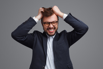 Angry businessman tearing hair out