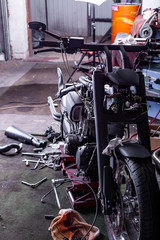 Cropped close up shot of beautiful and custom made motorcycle in the workshop