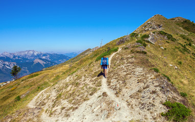 Fototapeta na wymiar Tourist on the mountain trail, Beautiful summer landscape on background