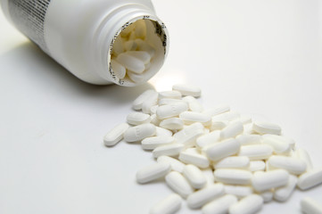 pills and bottle on white background