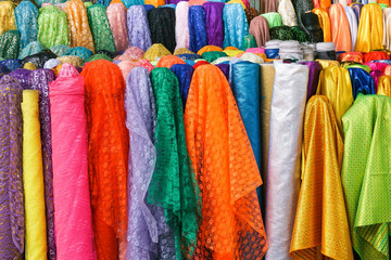 Rolls colorful of brightly coloured fabrics and cloths store
