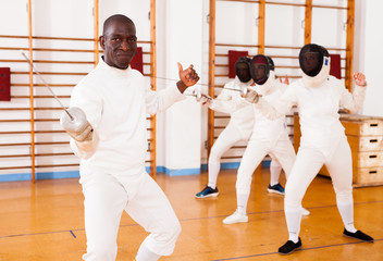 Sporty african american man fencer practicing effective fencing techniques