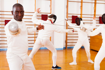African american man fencer in training room