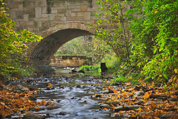 Fototapeta na wymiar Stone bridge over a creek