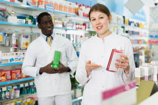 two pharmacists offering medication