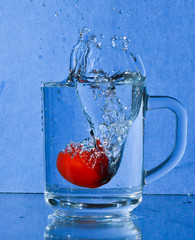 tomatoes in glass of water
