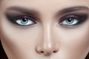 Young beautiful girl with purple make-up