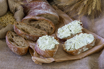 Ciabatta with ears and cream on the wooden table