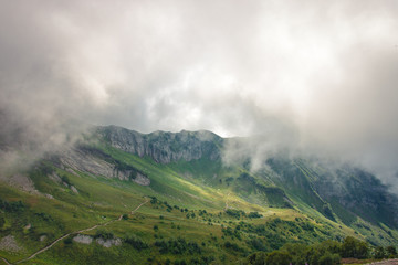 Fototapeta na wymiar Rocky Mountains cliff and clouds fog. Nature landscape