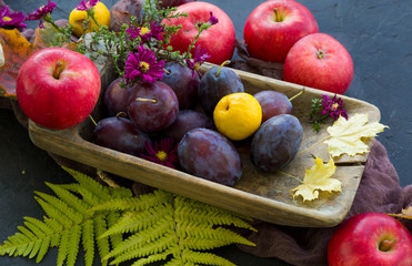 fresh fruits and vegetables with flowers on the wooden plate