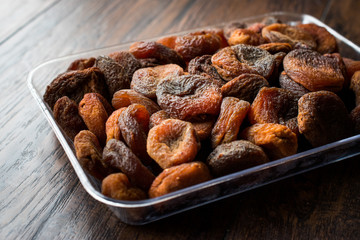 Fototapeta premium Turkish Style Sun-dried Apricots in Plastic Box / Container.