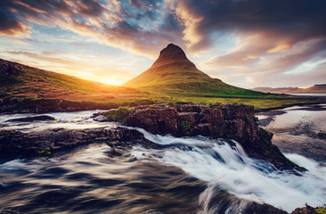 Fantastic evening with Kirkjufell volcano. Location famous place Kirkjufellsfoss waterfall, Iceland, Europe.
