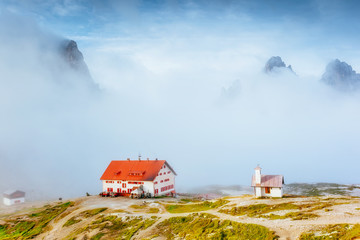 Great foggy view of the National park Tre Cime di Lavaredo. Location Dolomiti alps, Italy,