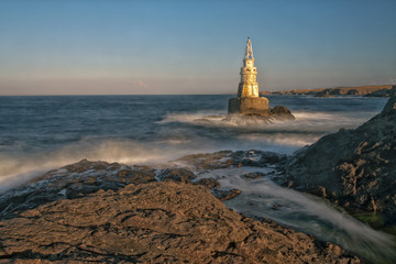 Lighthouse near sea shore.
