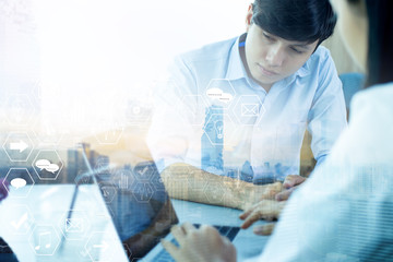 Male businessman and business woman are using laptops.