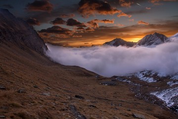 Great view of the foggy valley in Gran Paradiso National Park,  Alps, Italy,  dramatic scene, beautiful world. colourful autumn morning,scenic view with cloudy sky, majestic dawn in mountain landscape