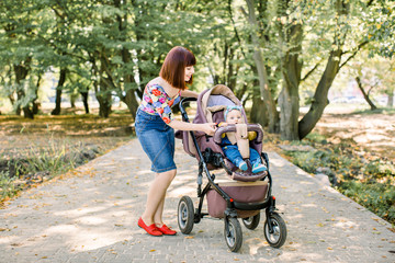 Baby and mother with the Alps mountains in nature in the background