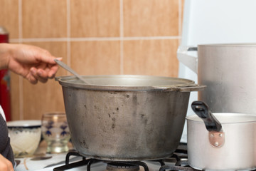 cooking food on the gas stove and the hand of man
