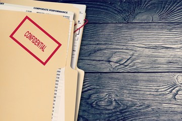 Folder with confidential papers on table