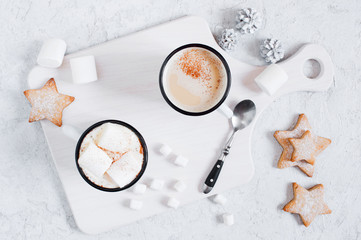 Two white mugs of hot cocoa with marshmallow