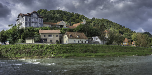 Fototapeta na wymiar River Savinja, houses in Breg and town park in Celje, Slovenia
