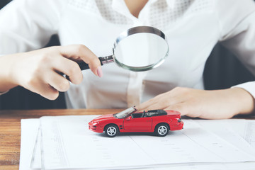 woman hand car model with magnifer