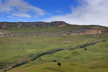 Obraz premium View of the mountain plateau in the clouds in the summer in the North Caucasus in Russia.