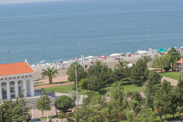 Fototapeta na wymiar View of the beach and the Black Sea shore of a small resort town Batumi in the suburbs of Georgia