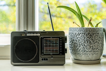 old retro radio with antenna on the window at home playing music f