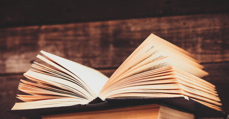 photo of the old books on the brown wooden background
