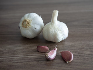 Garlic and cloves over wood