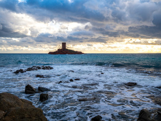 Fototapeta na wymiar castle island on the mediterranean sea shore at sunset