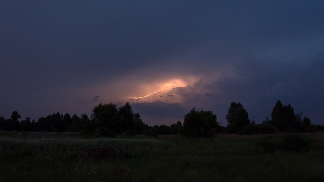 Lightning on a summer night over the forest