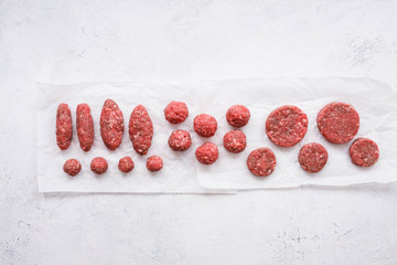 Uncooked beef meatballs, burger cutlets, beef patty, mince meat, ground beef meat, kebabs, top view