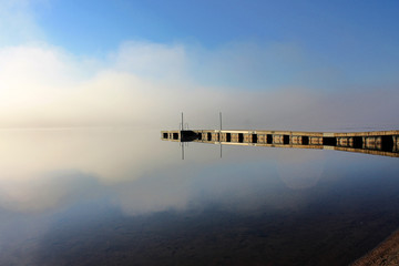 Early morning sketch by the foggy lake. Reflection ponton in the water. © zakob