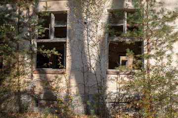 Fototapeta na wymiar A broken window in an old abandoned building. Broken glass on the window site. Old building.