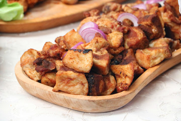 pork scrapes on a wooden plate
