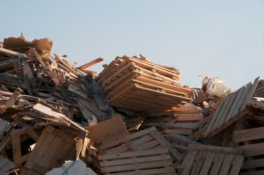 Pile Of Scrap Wood Pieces With A Blue Sky In The Background