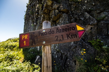 Wooden road sigh pointing Pico Ruivo at the highest walking path of Madeira island.