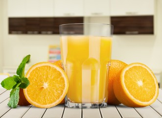 Orange juice and slices of orange on background