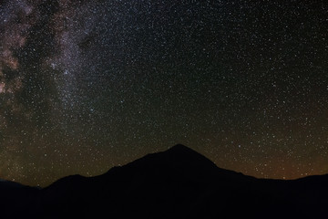 Fototapeta na wymiar The bright stars of the Milky Way in the night sky over the mountains of the North Caucasus.