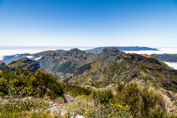 Fototapeta na wymiar Clouds and peaks at the top of the highest mountain of Madeira Pico Ruivo, Portugal