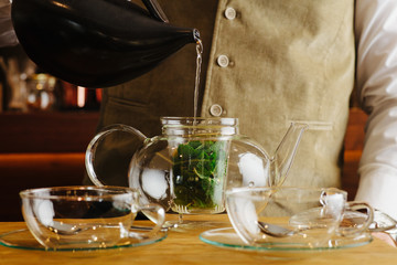 Image of a unrecognizable person making tea.