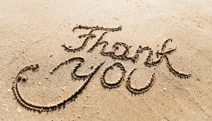 Thank you sign on sandy sea beach