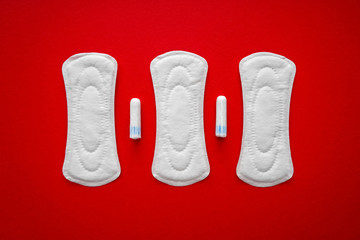 Menstrual pads with tampons on color background