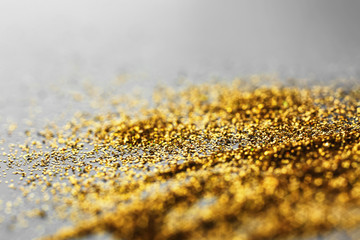 Shiny gold glitter on grey background