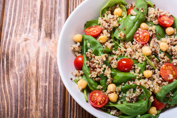 Spinach salad with quinoa , tomatoes and chickpea