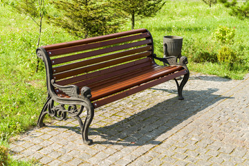 wooden bench, a seat in the park in the summer on a sunny day